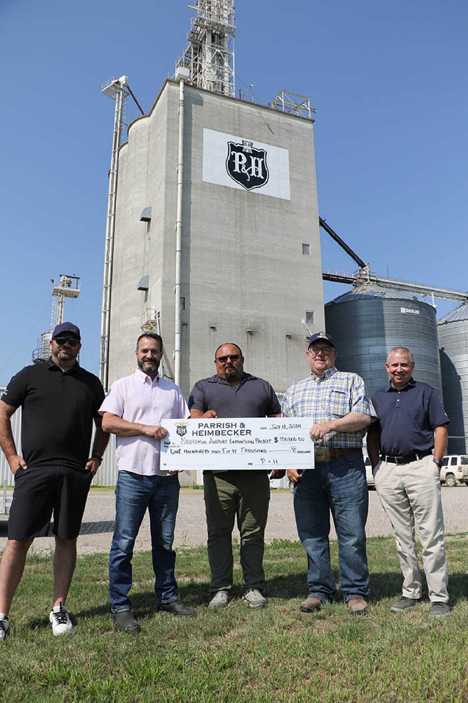 Parrish and Heimbecker donated $150,000 last week to the Moosomin Airport Expansion project. From left, Kristjan Hebert of the Community Builders Alliance (CBA), Justin Watson, Senior VP of Grain Origination and Crop Inputs, Cory Woywoda, General Manager at Moosomin P&H, RM of Moosomin Reeve Dave Moffatt, and Tyler Thorn of the CBA.